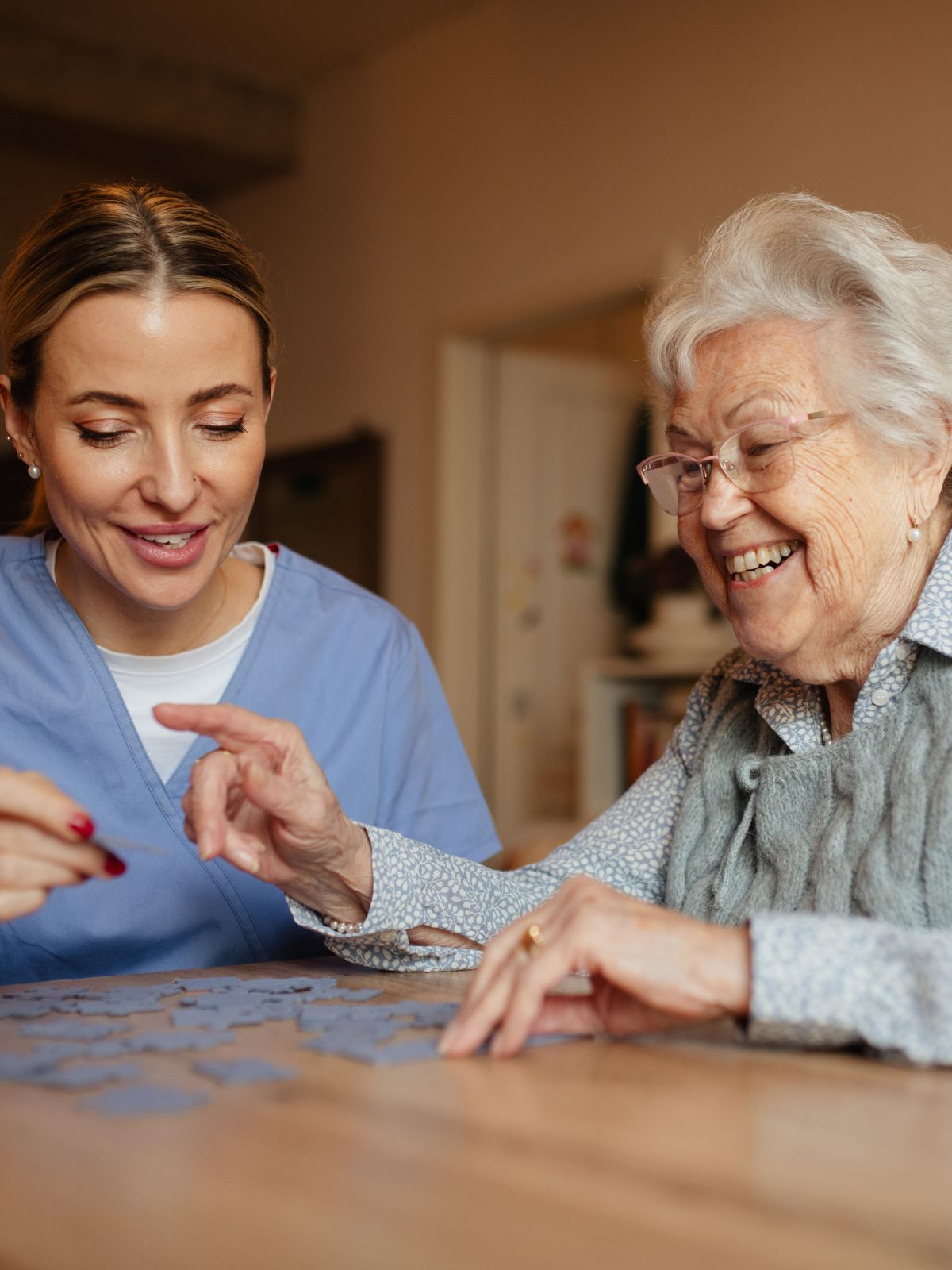 Professional caregiver assisting a senior with mobility support